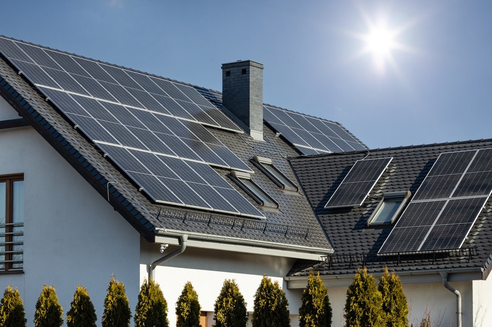 Toit de maison équipé de panneaux solaires sur l'ensoleillé, vue lumineuse et moderne. Qu'est-ce qu'un crm sur mesure intégré?